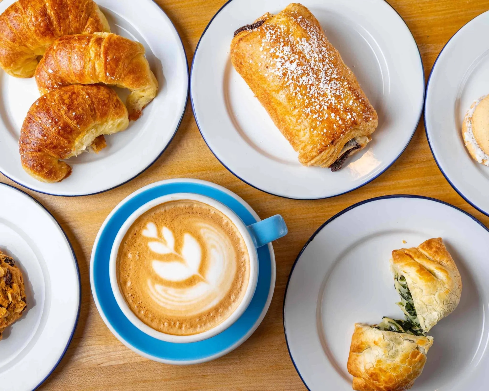 top view of pasteries and a latte in a ceramic mug