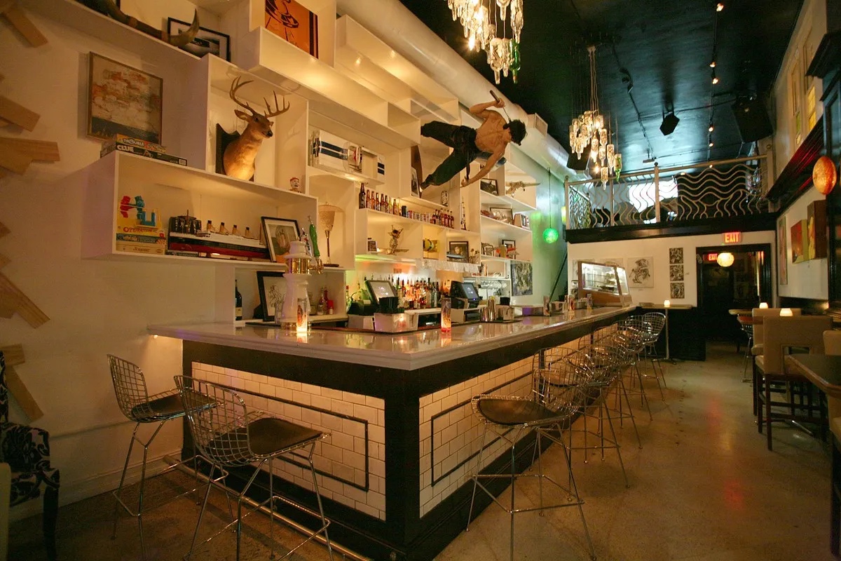 Kill Your Idol bar interior with staute of Bruce Lee with sideways on the wall