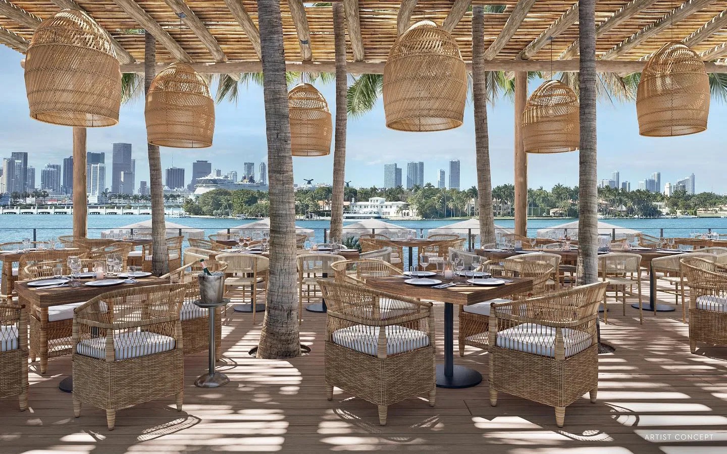 Outside deck seating of wicker and bamboo furniture with dappled light through the bamboo roof