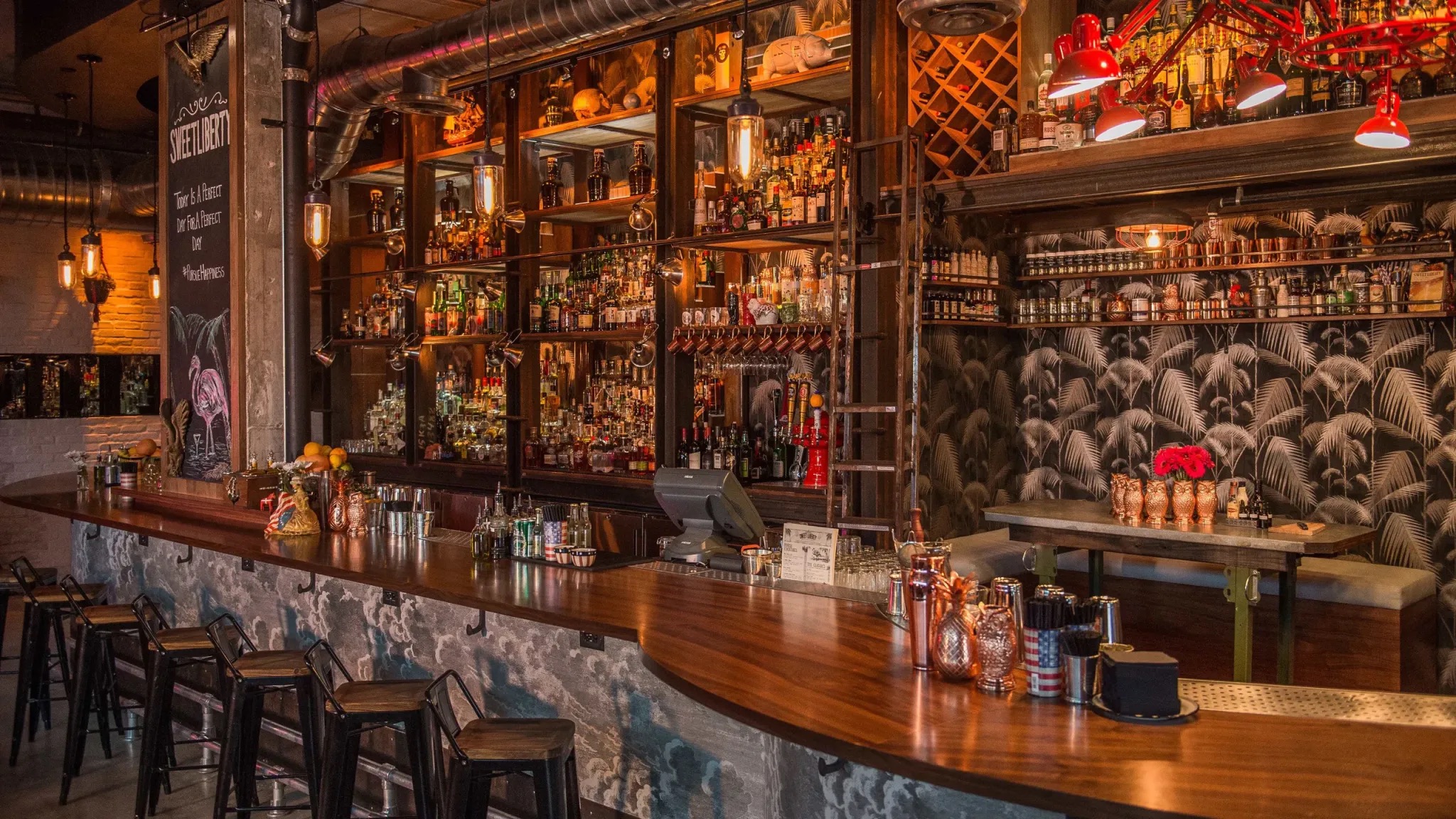 Interior of Sweet Liberty Drinks with a wooden bar top