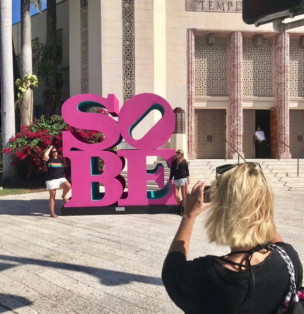Woman taking picture of SoBe public art installation